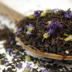 earl grey blue flower black tea on a wooden spoon