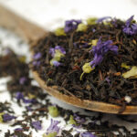 earl grey blue flower black tea on a wooden spoon