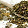 Dragon Fruit Exotic Green and White tea blend on a wooden spoon