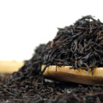 black vanilla tea on a wooden spoon