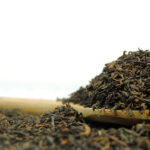 an aged yunnan black tea on a wooden spoon