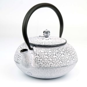 white japanese cast iron teapot with flower design